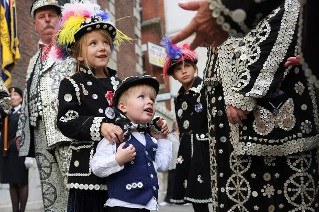 Pearly Prince of Harrow Harrison Ferrari, 3, and Pearly Princesses of Harrow Ariana Ferrari, 7, and Esme Ferrari, 9, stand, on the day of the Harvest Festival service at the Guildhall, in London, Britain on September 24, 2023. (Photo by Hollie Adams/Reuters)