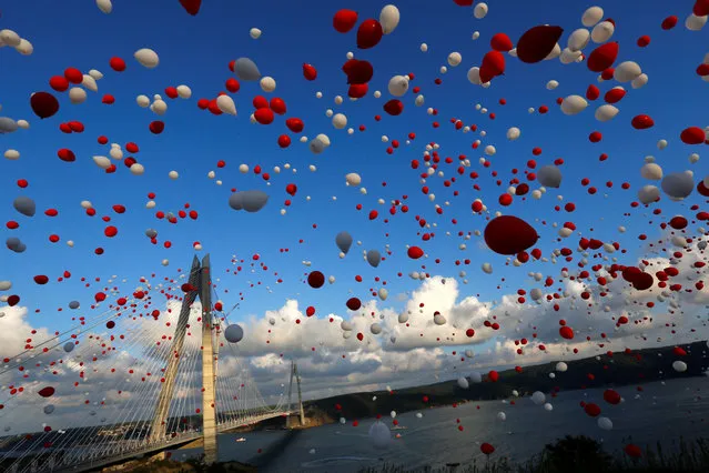 TURKEY: Red and white balloons are released during the opening ceremony of newly built Yavuz Sultan Selim bridge, the third bridge over the Bosphorus linking the city's European and Asian sides in Istanbul, Turkey, August 26, 2016. (Photo by Murad Sezer/Reuters)