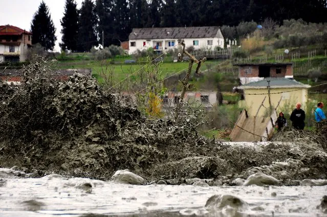 Water and other liquids run out at the Albanian village of Marinze, 130 kilometers (80 miles) south of the capital Tirana Thursday April 1, 2015. Albanian authorities are evacuating residents of Marinze following an explosion at a Canadian-owned oil well. No injuries were reported. A statement from the Calgary-based Bankers Petroleum Ltd. said an “uncontrolled leak of natural gas occurred during drilling operation”. (Photo by Hektor Pustina/AP Photo)