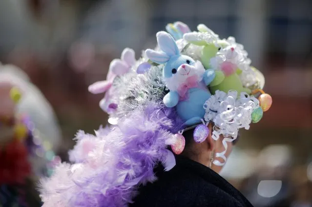 A woman wears an Easter bonnet decorated with stuffed bunnies as she stands on the boardwalk before Asbury Park's 80th annual Easter Parade on Sunday, April 5, 2015, in Asbury Park, N.J. (Photo by Mel Evans/AP Photo)