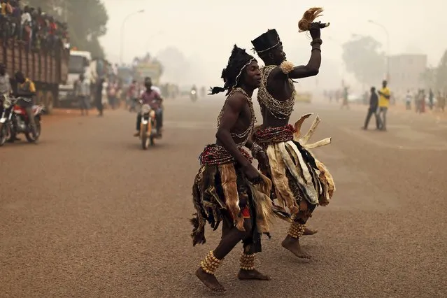 Supporters of presidential candidate Faustin-Archange Touadera dressed in traditional costumes dance during a campaign ahead of Sunday's second round election against Anicet-Georges Dologuele in Bangui, Central African Republic, February 12, 2016. (Photo by Siegfried Modola/Reuters)