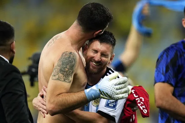 Argentina's Lionel Messi embraces teammate, goalkeeper Emiliano Martinez, as they celebrate their team's 1-0 victory over Brazil at the end of a qualifying soccer match for the FIFA World Cup 2026, at the Maracana stadium in Rio de Janeiro, Brazil, Tuesday, November 21, 2023. It was Brazil's first home defeat ever in a World Cup qualifying game. (Phoot by Silvia Izquierdo/AP Photo)