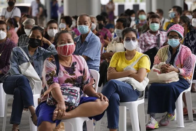 Residents wait to receives shots of the AstraZeneca COVID-19 vaccine at the Central Vaccination Center in Bangkok, Thailand, Thursday, July 15, 2021. As many Asian countries battle against a new surge of coronavirus infections, for many their first, the slow-flow of vaccine doses from around the world is finally picking up speed, giving hope that low inoculation rates can increase rapidly and help blunt the effect of the rapidly-spreading delta variant. (Photo by Sakchai Lalit/AP Photo)