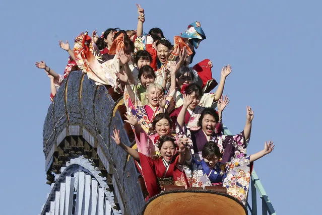Kimono-clad women who celebrate turning 20 years old react as they ride a roller coaster following a coming of age ceremony at Toshimaen amusement park on Coming of Age Day, a national holiday, in Tokyo, Monday, January 14, 2019. (Photo by Koji Sasahara/AP Photo)