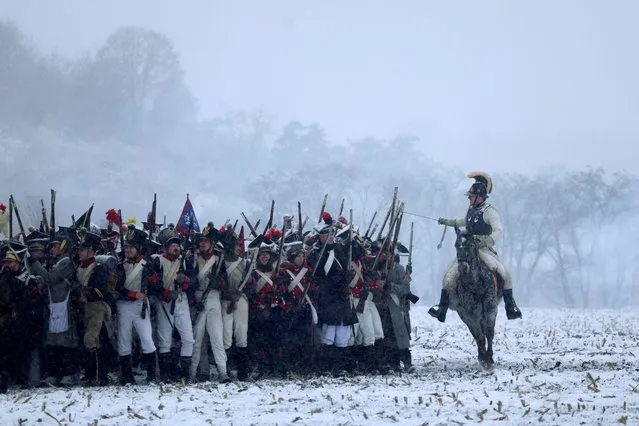 History enthusiasts, dressed as soldiers, fight during the re-enactment of Napoleon's famous battle of Austerlitz near the southern Moravian town of Slavkov u Brna, Czech Republic on December 2, 2023. (Photo by David W. Cerny/Reuters)