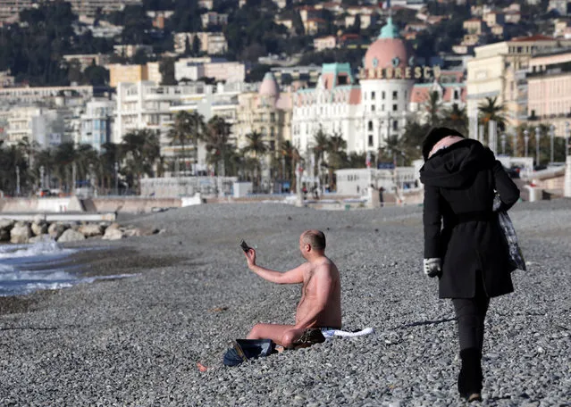 A man in swimsuit takes a selfie on the beach of the Promenade des Anglais during a cold and sunny winter's day in Nice, France, January 17, 2017. (Photo by Eric Gaillard/Reuters)