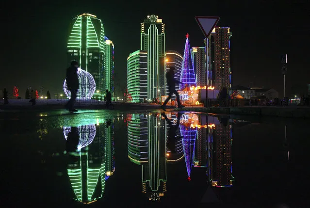 A Christmas tree and skyscrapers illuminated for New Year celebration are seen in downtown Grozny, the capital of Chechnya, Russia, Wednesday, December 28, 2016. (Photo by Musa Sadulayev/AP Photo)