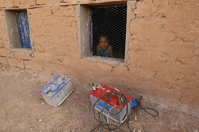 An indigenous Sahrawi girl looks over a window in a refugee camp of Al Smara in Tundouf, southern Algeria March 2, 2016. (Photo by Zohra Bensemra/Reuters)
