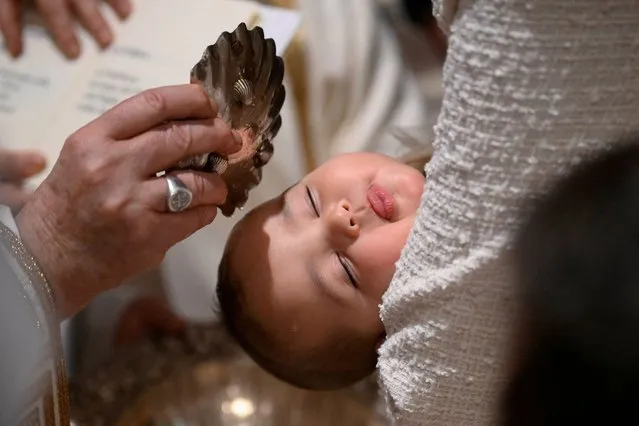 Pope Francis baptises a baby during a Mass in the Sistine Chapel, as he marks the Feast of Baptism of the Lord at the Vatican on January 7, 2024. (Photo by Vatican Media­via Reuters)