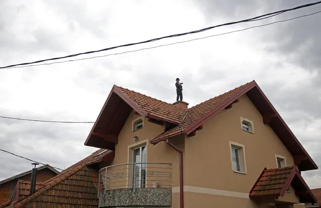 Dajana Djuric, 25, who has worked as a chimney sweep since the age of six, poses for a photograph as she stands on a roof of a house in Brcko, Bosnia and Herzegovina. Picture taken March 3, 2016. (Photo by Dado Ruvic/Reuters)