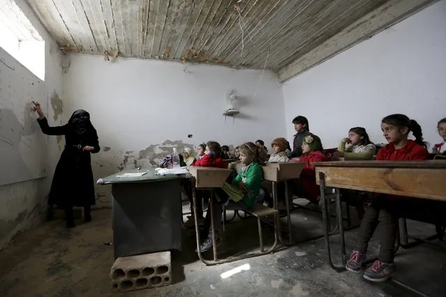 Students attend a class inside the Freedom School, in the town of al-Tamanah, in the southern countryside of Idlib, Syria, March 9, 2016. (Photo by Khalil Ashawi/Reuters)