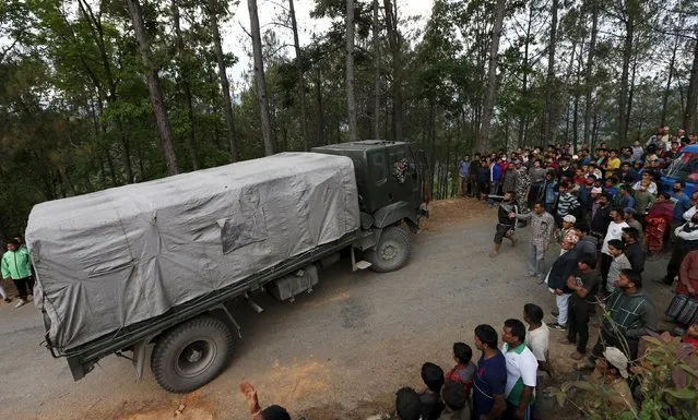 People force an army truck carrying relief supplies off the road, saying they have not received any government food aid five days after Saturday's earthquake, near Chautara, Nepal, April 29, 2015. (Photo by Olivia Harris/Reuters)