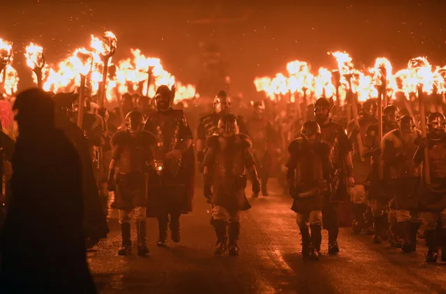 The Jarl squad begin to light torches at the culmination of Up Hell Aa on January 31, 2017 in Lerwick, Shetland. The traditional festival of fire, known as Up Helly Aa, takes place annually on the last Tuesday of January. (Photo by Jeff J. Mitchell/Getty Images)
