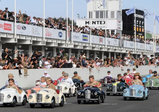 Children take part in the Settrington Cup Pedal Car Race as motoring enthusiasts attend the Goodwood Revival, a three-day historic car racing festival in Goodwood, Chichester, southern Britain, September 18, 2021. (Photo by Toby Melville/Reuters)