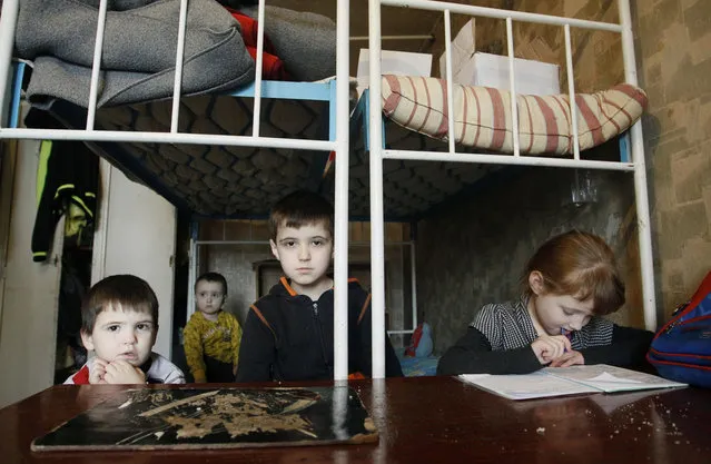 The Shevchenkos children play in a hostel room after being evacuated from their home on the outskirts of Donetsk that was constantly shelled, in Ukraine, Thursday, February 2, 2017. In the rebel stronghold of Donetsk, the self-proclaimed authorities said two civilians were injured Wednesday evening when projectiles hit their houses in Donetsk's north. (Photo by Alexander Ermochenko/AP Photo)