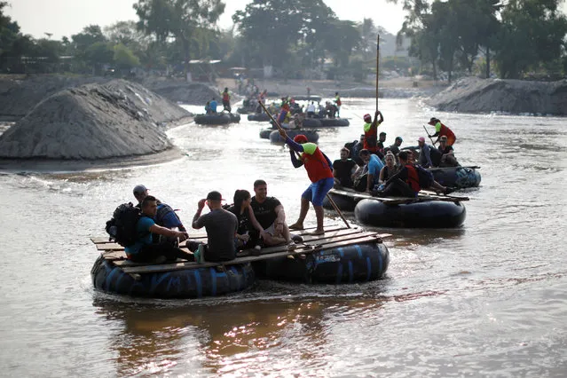 Migrants from Cuba en route to the United States, ride on rafts across the Suchiate river from Tecun Uman, Guatemala to Ciudad Hidalgo, Mexico, April 7, 2019. (Photo by Jose Cabezas/Reuters)