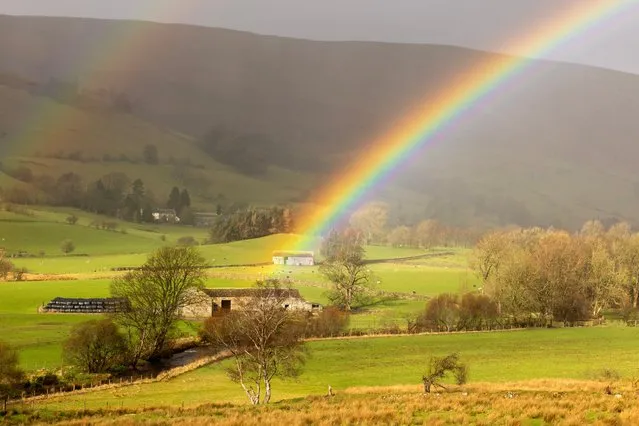 A rainbow appears to strike gold on a farm near Threlkeld, just outside Keswick in Cumbria, UK in the last decade of February 2024. (Photo by Andrew McCaren for The Times)