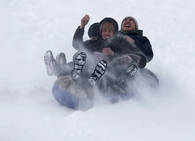 People enjoy sled rides at the village of Prokhladnoye, about 30 km from Bishkek, Kyrgyzstan, 18 February 2024. The Snow covered large areas in the region and the temperature was below -12- 17 degrees Celsius. (Photo by Igor Kovalenko/EPA/EFE)