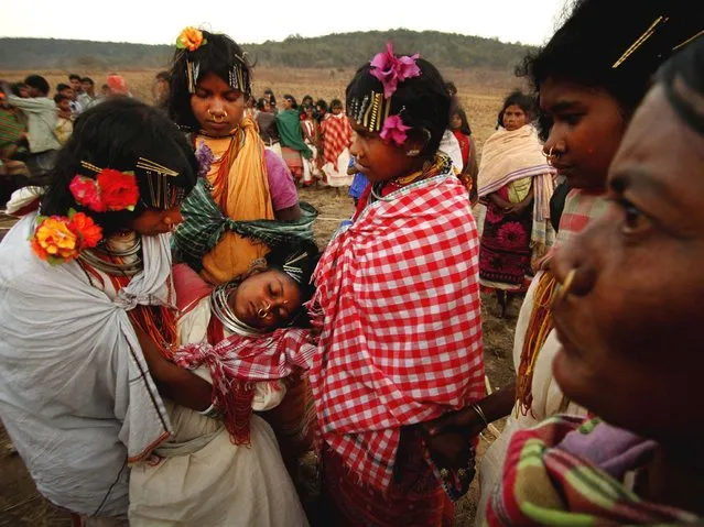 A member of Dongria tribe girl faints after dancing in trance during the two-day long Niyamraja Festival atop of the Niyamgiri hills near Lanjigarh in Kalahandi district, Orissa state. (Photo by Biswaranjan Rout/AP Photo)