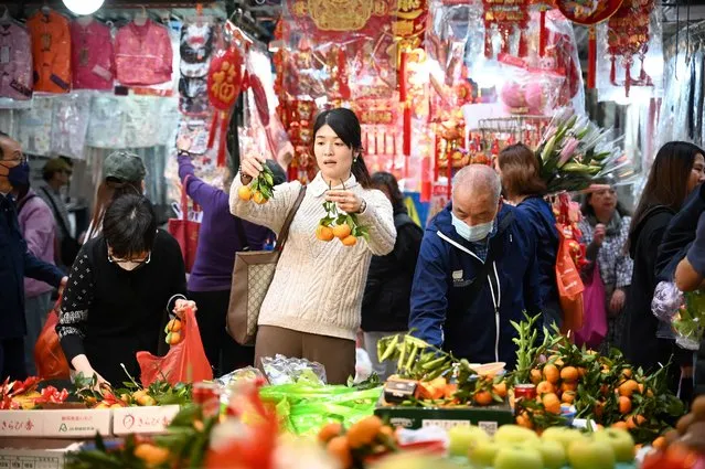 People shop at a market ahead of the Lunar New Year in Hong Kong on February 6, 2024 ahead of the Lunar New Year of the Dragon which falls on February 10. (Photo by Peter Parks/AFP Photo)