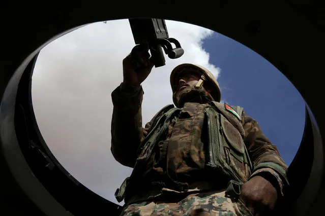 In this picture taken Tuesday, February 14, 2017, a Jordanian soldier stands at the north eastern border with Syria, close to the informal Rukban camp. The commander of Jordan's border guards says Islamic State extremists are expanding their influence in the sprawling border camp for tens of thousands of displaced Syrians, posing a growing threat to the U.S.-allied kingdom. (Photo by Raad Adayleh/AP Photo)