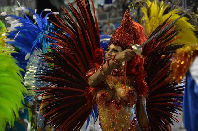 A reveler of the Academicos do Tatuape samba school performs during the second night of carnival parade at the Sambadrome in Sao Paulo, Brazil on March 2, 2014. (Photo by Nelson Almeida/AFP Photo)