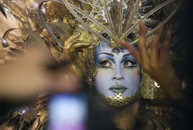 A costumed guest poses for photographers during the opening ceremony of the Life Ball in front of City Hall in Vienna, Austria, Saturday, May 16, 2015. (Photo by Herwig Prammer/AP Photo)