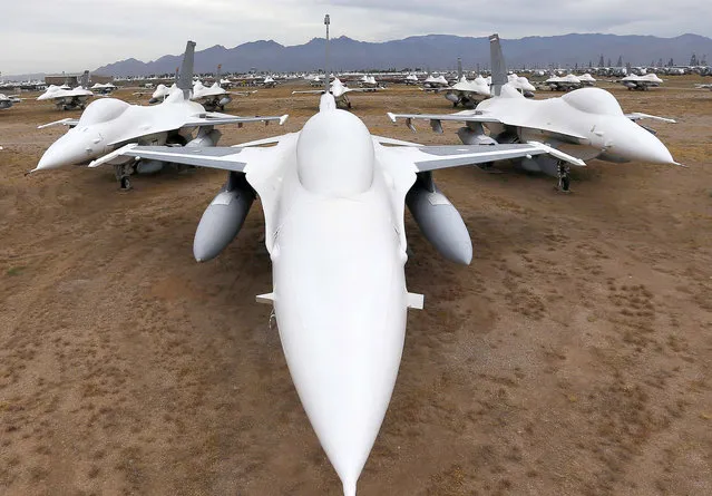 F-16 Fighting Falcons covered in sealing paint sit in a field along Miami St. at the 309th Aerospace Maintenance and Regeneration Group boneyard at Davis-Monthan Air Force Base in Tucson, Ariz. on Thursday, May 21, 2015. Over 4,500 variants of the F-16's have been produced since 1973. This field of fighters will become drone target planes in the future. (Photo by Matt York/AP Photo)