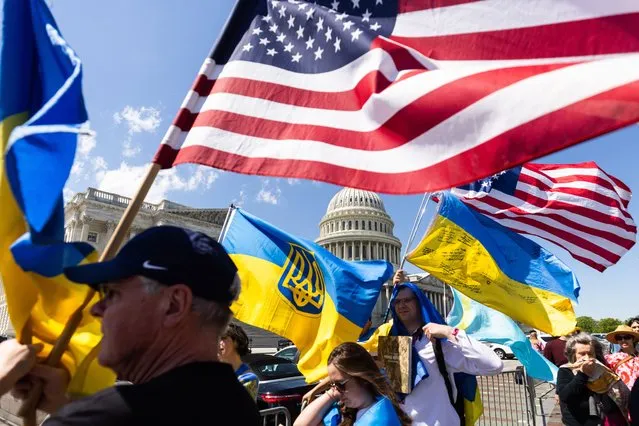 Supporters of Ukraine wave US and Ukrainian flags outside the US Capitol after the House approved foreign aid packages to Ukraine, as well as Israel and Taiwan in the US Capitol in Washington, DC, USA, 20 April 2024. Senate Majority Leader Chuck Schumer has vowed to advance the foreign aid packages as soon as next week. (Photo by Jim Lo ScalzoEPA)