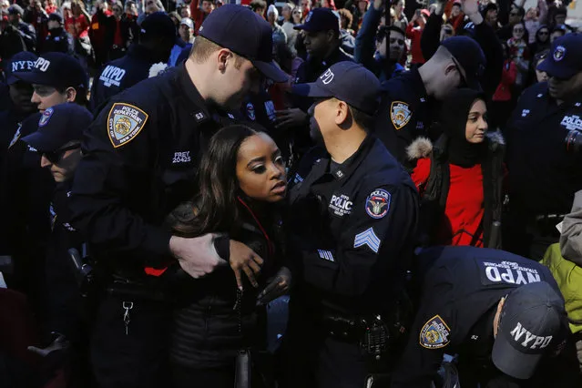 New York Police Department officers detain organizer Tamika Mallory as she takes part in a “Day Without a Woman” march on International Women's Day in New York, March 8, 2017. (Photo by Lucas Jackson/Reuters)