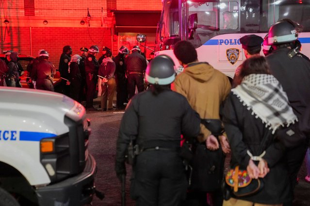 Police detain protestors, as other police officers enter the campus of Columbia University, in New York City on April 30, 2024. (Photo by David Dee Delgado/Reuters)