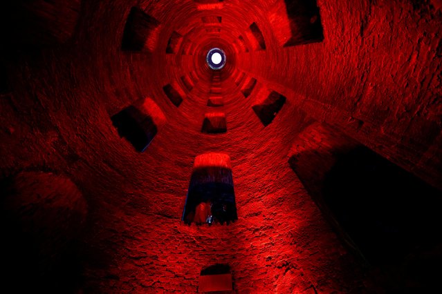 Peoples sit as couples gather over the weekend to celebrate Valentine's Day by descending 54 metres (177 feet) down a 16th century St. Patrick's Well of Orvieto, Italy on February 11, 2023. (Photo by Yara Nardi/Reuters)