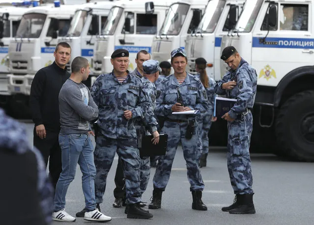 Russian policemen on patrol, prior to an unsanctioned rally in the center of Moscow, Russia, Saturday, August 3, 2019. Police in Moscow have detained a leading opposition figure as she was heading to an unauthorized rally and march protesting the exclusion of independent and opposition candidates from the Moscow city council election. Lyubov Sobol, who is one of the aspirants rejected from the ballot, has been detained in central Moscow and taken away in a police van. Police have detained dozens of other demonstrators. (Photo by Pavel Golovkin/AP Photo)