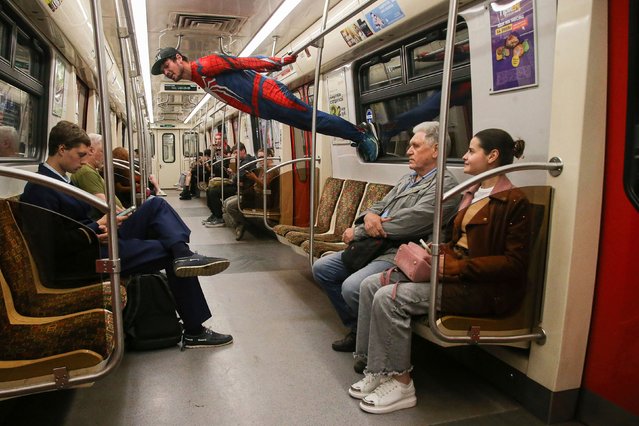 An acrobat dressed as Spider-Man performs in a subway train in St. Petersburg, Russia, on Tuesday, June 11, 2024. (Photo by Artem Priakhin/SOPA Images/Sipa USA/AP Photo)