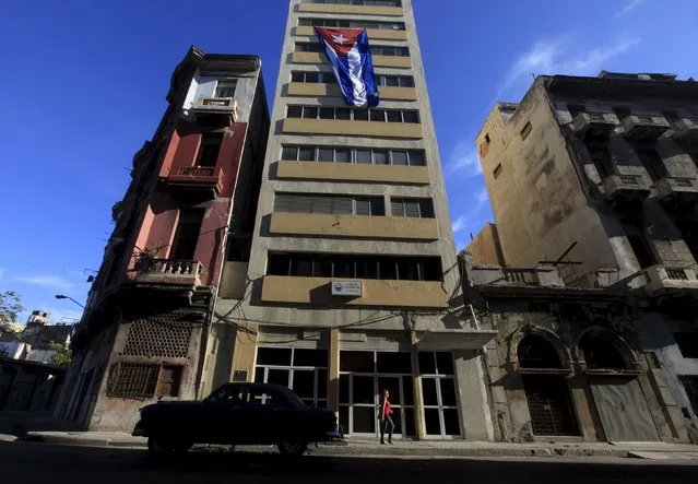 A Cuban flag hangs on a building in Havana, Cuba April 24, 2016. (Photo by Enrique de la Osa/Reuters)