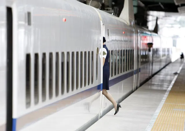 A woman walks into a carriage of a Beijing -Tianjin Intercity Railway train in Beijing Friday, August 01, 2008. (Photo by Kim Kyung-Hoon/Reuters)