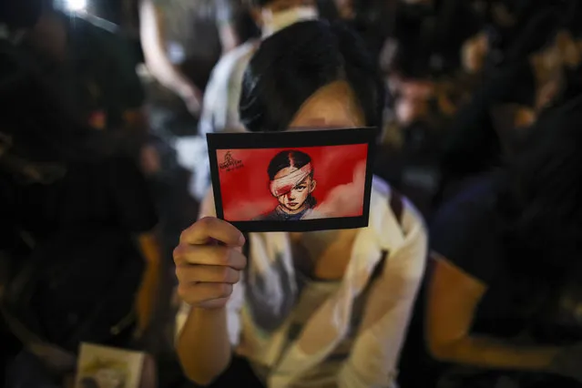 A woman holds the placard during a rally at Edinburgh Place, Hong Kong, China, 27 September 2019. Hong Kong has entered its fourth month of mass protests, originally triggered by a now suspended extradition bill to mainland China that have turned into a wider pro-democracy movement. (Photo by Fazry Ismail/EPA/EFE)