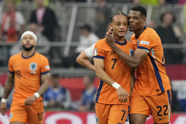 Xavi Simons of the Netherlands, center, celebrates with Denzel Dumfries of the Netherlands after scoring his sides first goal during a semifinal match between the Netherlands and England at the Euro 2024 soccer tournament in Dortmund, Germany, Wednesday, July 10, 2024. (Photo by Frank Augstein/AP Photo)