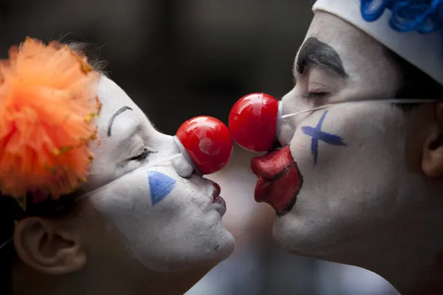 A couple dressed as clowns participate in the “Cordao da Bola Preta” street carnival parade in Rio de Janeiro, Brazil, Saturday, February 9, 2013. According to Rio's tourism office, Rio's street Carnival this year will consist of 492 block parties, attended by an estimated five million Carnival enthusiasts. (Photo by Felipe Dana/AP Photo)
