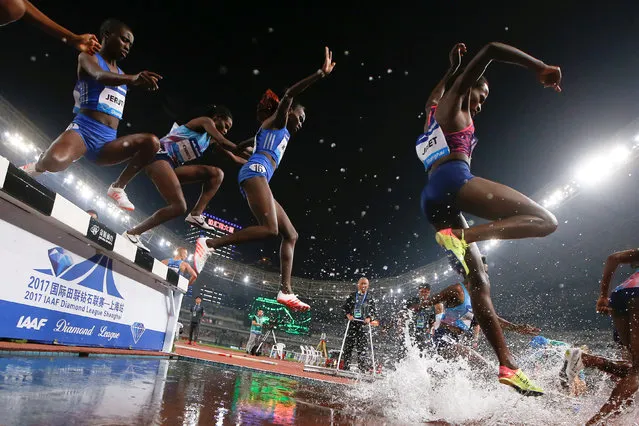 IAAF Athletics Diamond League meeting, Women's 3000m steeplechase, Shanghai Stadium, Shanghai, China on May 13, 2017. Competitors jump into the water during the women's 3,000m steeplechase. (Photo by Aly Song/Reuters)