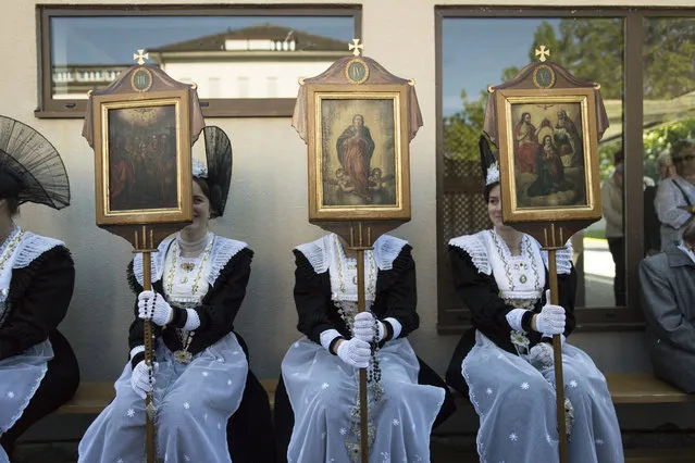 Women in traditional costumes take part in  the eucharistic celebration on the occasion of the Feast of Corpus Christi in Appenzell, Switzerland, 26 May 2016. (Photo by Gian Ehrenzeller/EPA)