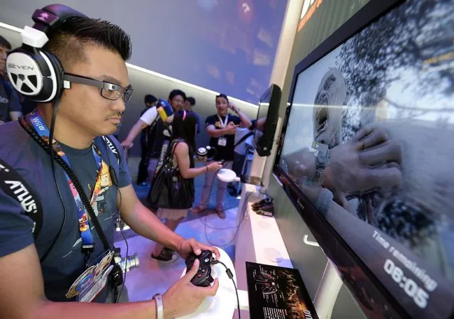 Danilo Napalan plays the new zombie survival game "Dying Light " in the Warner Bros. booth at the 2014 Electronic Entertainment Expo, known as E3, in Los Angeles, June 10, 2014.  REUTERS/Kevork Djansezian