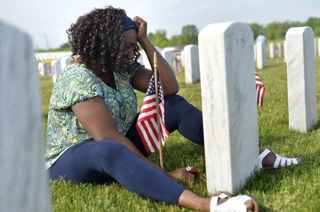 Frances Jockwig, of Gladwin, cries as she visits her husband's grave on Sunday, May 29, 2016, the morning before a Memorial Day ceremony honoring deceased veterans at Great Lakes National Cemetery in Holly,Mich. (Photo by Rachel Woolf/The Flint Journal-MLive.com via AP Photo)