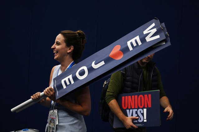 People hold signs at the United Center, before the start of Day 2 of the Democratic National Convention (DNC) in Chicago, Illinois, U.S., August 20, 2024. (Photo by Callaghan O'hare/Reuters)