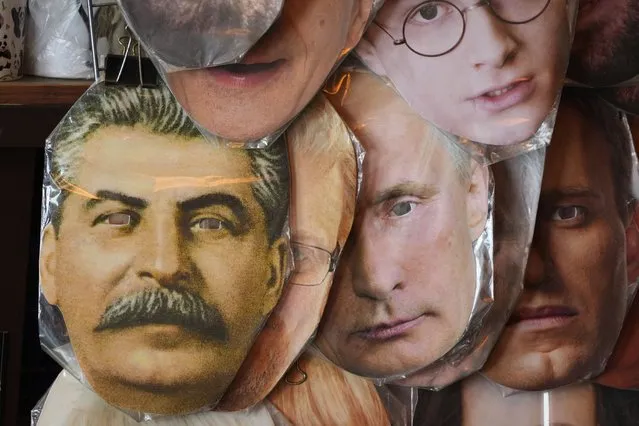 Face masks depicting Russian President Vladimir Putin, centre, Soviet dictator Josef Stalin, left, and and jailed Russian opposition leader Alexei Navalny, right, among others are displayed for sale at a street souvenir shop in St. Petersburg, Russia, Sunday, May 1, 2022. (Photo by AP Photo/Stringer)