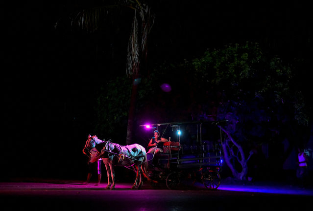 A horse-drawn vehicle and it's owners wait for passengers during a power outage caused by breakdowns forcing six plants to go off-line on the grid, according to the state run power company, in Matanzas, Cuba on August 22, 2024. (Photo by Norlys Perez/Reuters)