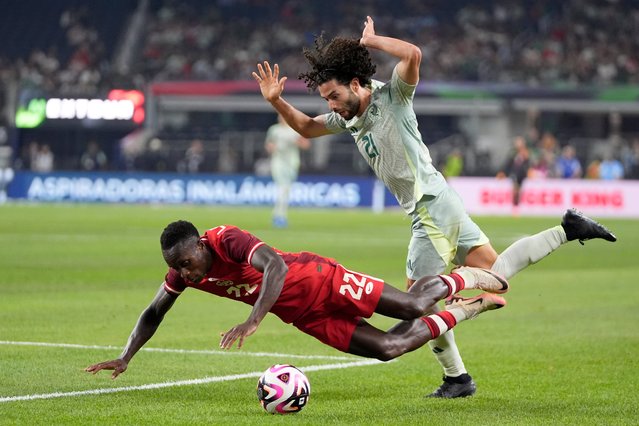 Canada defenseman Richie Laryea (22) is knocked down by Mexico midfielder Cesar Huerta (21) as they compete in the second half of an international friendly soccer match, Tuesday, September 10, 2024, in Arlington, Texas. (Photo by Tony Gutierrez/AP Photo)