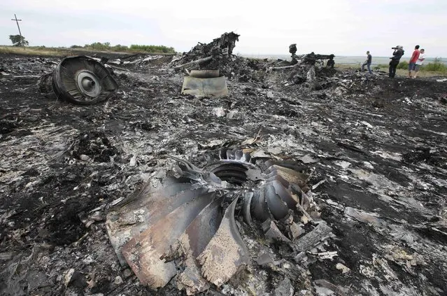Debris is seen at the site of Thursday's Malaysia Airlines Boeing 777 plane crash near the settlement of Grabovo, in the Donetsk region July 18, 2014. World leaders demanded an international investigation into the shooting down of Malaysia Airlines Flight MH17 with 298 people on board over eastern Ukraine, as Kiev and Moscow blamed each other for a tragedy that stoked tensions between Russia and the West. (Photo by Maxim Zmeyev/Reuters)