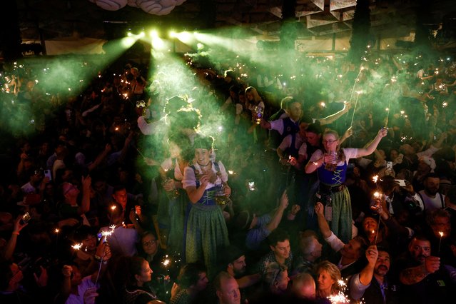 Oktoberfest waitstaff celebrate the end of the world’s biggest beer festival, the 189th Oktoberfest, in Munich, Germany, on October 6, 2024. (Photo by Michaela Stache/Reuters)