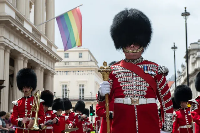 A marching band makes its way past a rainbow flag flying from a building as the LGBT community celebrates Pride in London on June 25, 2016 in London, England. Across the city performances and speeches take place as a parade makes it way through the centre ending in Trafalgar Square. 2016 Pride in London comes just two weeks after Omar Mateen shot dead 50 people at Pulse, a gay nightclub in Orlando, Florida. (Photo by Chris J. Ratcliffe/Getty Images)